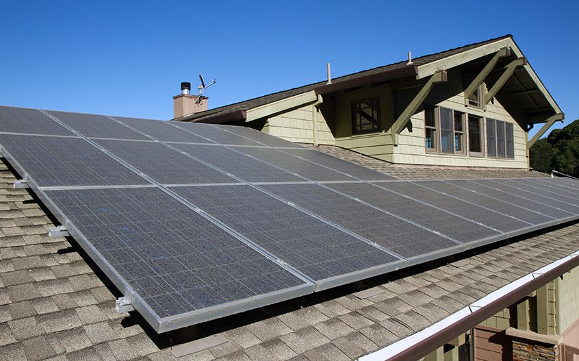 A solar panel on the roof of a house.