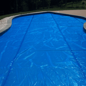 A pool cover is being used to protect the swimming area.