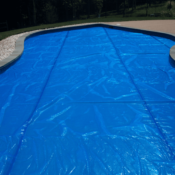 A pool cover is being used to protect the swimming area.